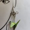 Aretes en forma de grullas voladoras.